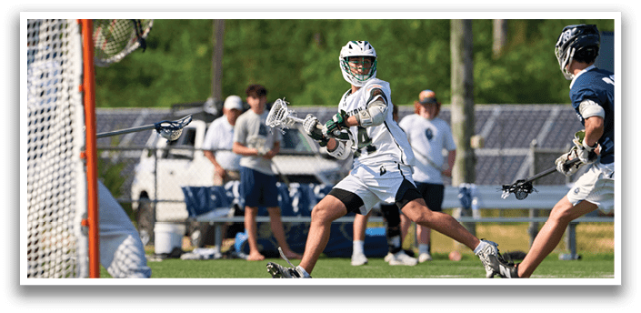 A man in a green shirt and white shorts is running towards a goal. Description generated by AI