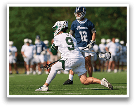 A man in a white uniform is playing lacrosse. Description generated by AI