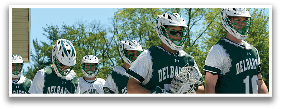 A group of people wearing green and white uniforms. Description generated by AI