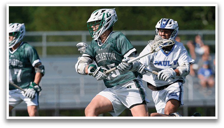 A man in a green shirt and white shorts is running with a lacrosse stick. Description generated by AI