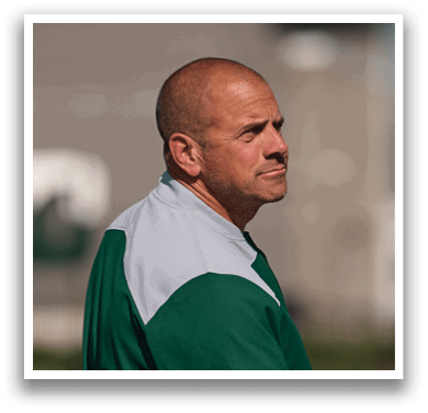A man wearing a green and white jacket. Description generated by AI