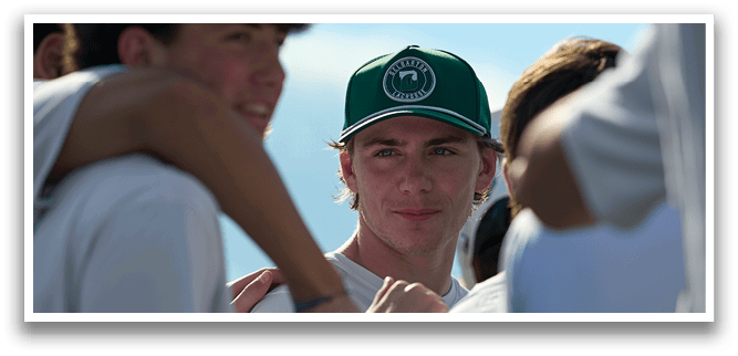 A group of people wearing white shirts and green hats. Description generated by AI