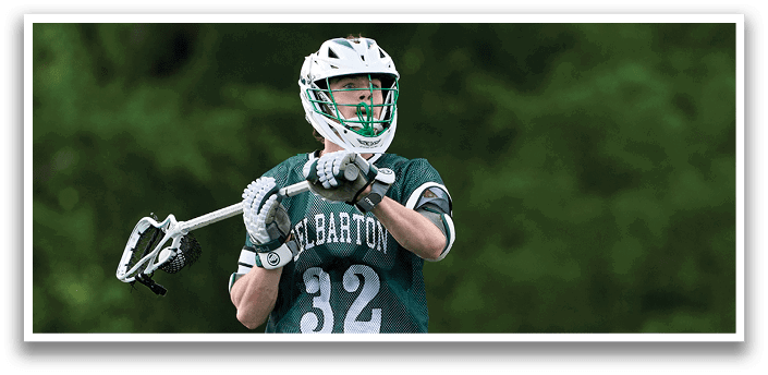 A man wearing a green and white jersey is running on a field. Description generated by AI