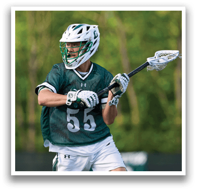 A man wearing a green and white jersey and white shorts. Description generated by AI