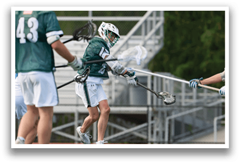 A group of people playing a game of lacrosse. Description generated by AI