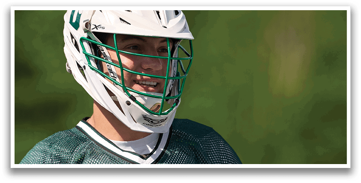 A man wearing a green and white helmet. Description generated by AI