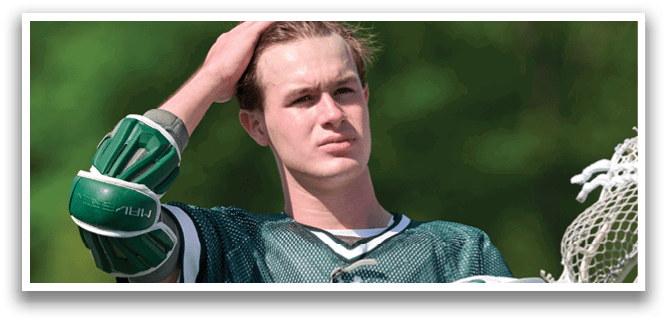 A man with a green and white jersey is holding a catcher's mitt. Description generated by AI