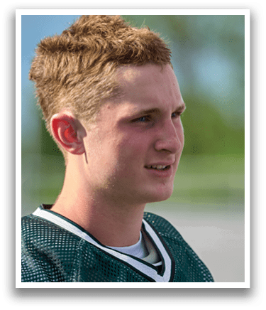 A man wearing a green and white jersey. Description generated by AI