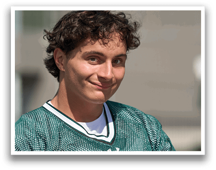 A man wearing a green and white jersey. Description generated by AI