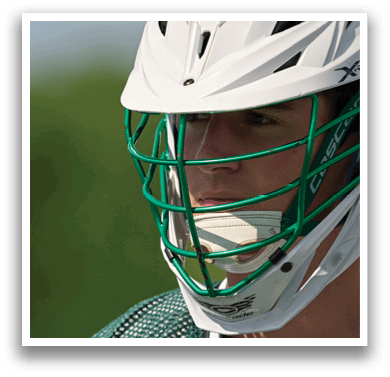 A man wearing a green and white helmet. Description generated by AI