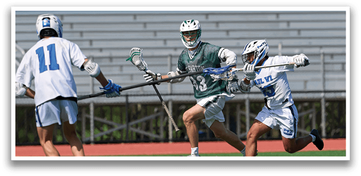 A man in a green shirt and white shorts is running with a lacrosse stick. Description generated by AI