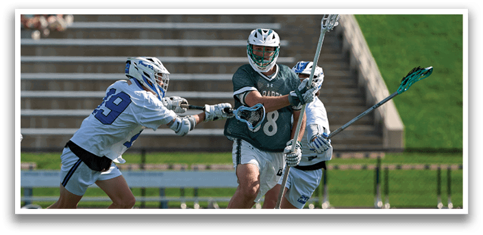 A group of men playing lacrosse. Description generated by AI