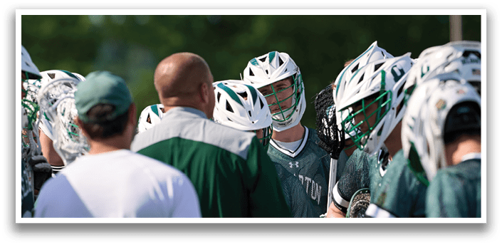 A group of people wearing green and white uniforms. Description generated by AI