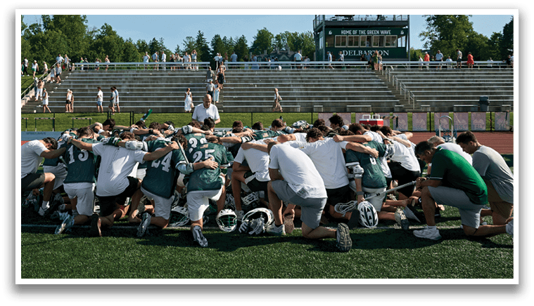 A group of men wearing green and white uniforms. Description generated by AI