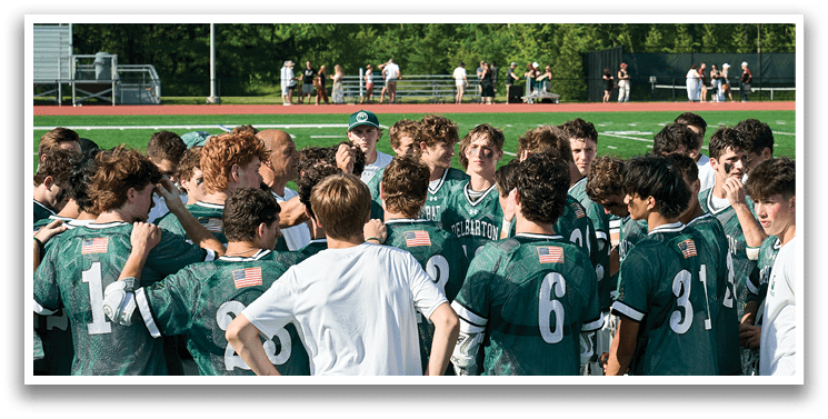A man wearing a green and white uniform is running on a field. Description generated by AI