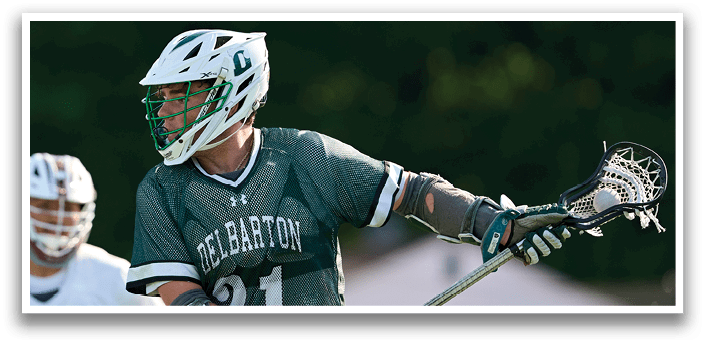 A man wearing a green and white jersey is running on a field. Description generated by AI