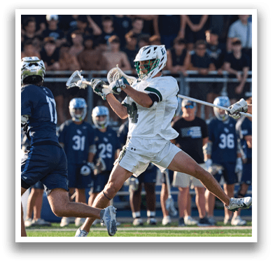 A man holding a lacrosse stick. Description generated by AI