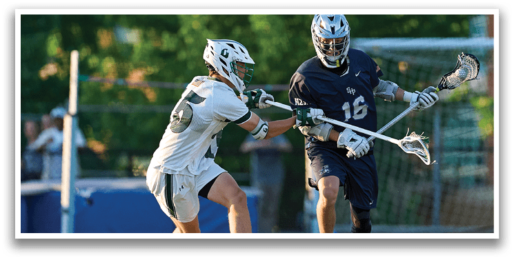 A man in a green shirt is running with a lacrosse stick. Description generated by AI