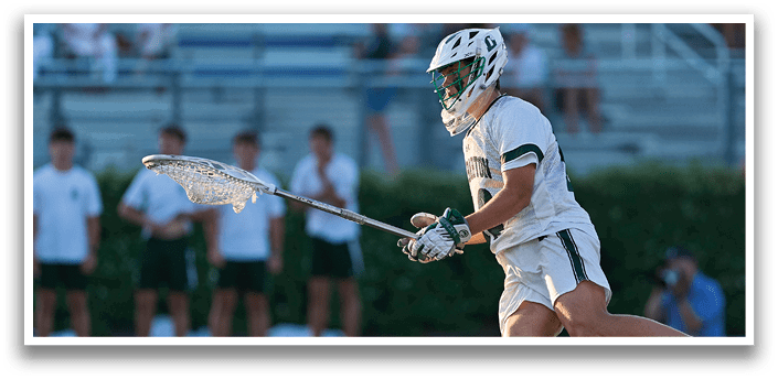A man wearing a green and white jersey with the number 35 on it. Description generated by AI