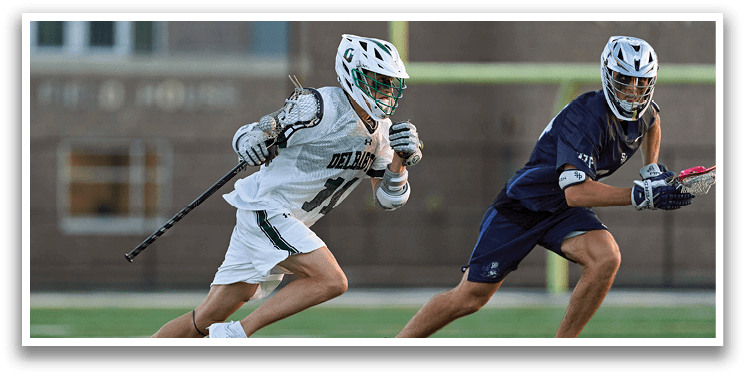 A man wearing a green and white uniform is running on a field. Description generated by AI