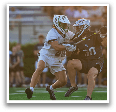 A man holding a lacrosse net. Description generated by AI
