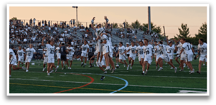 A man wearing a green and white jersey is running on a field. Description generated by AI