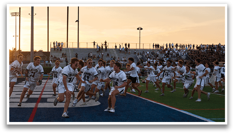 A group of men wearing green and white uniforms. Description generated by AI