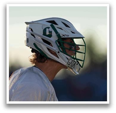 A man holding a lacrosse net. Description generated by AI