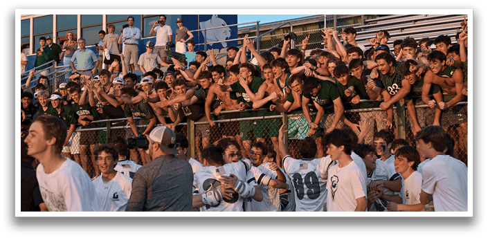 A man wearing a green and white jersey is running on a field. Description generated by AI