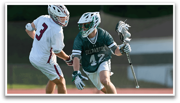 A man is sliding on the ground while another man is holding a lacrosse stick. Description generated by AI