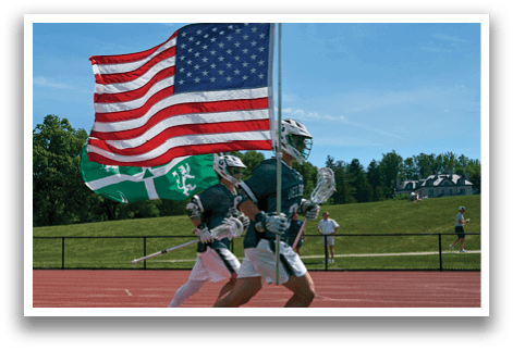 A referee is talking to a player in a green and white uniform. Description generated by AI