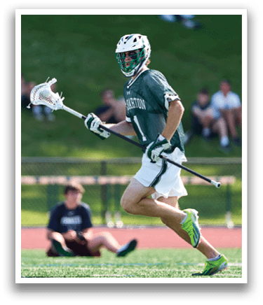 A man wearing a green and white shirt and white shorts is running on a field. Description generated by AI