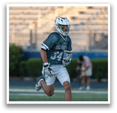 A man holding a lacrosse net. Description generated by AI