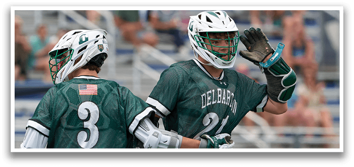 A group of lacrosse players wearing green and white uniforms. Description generated by AI