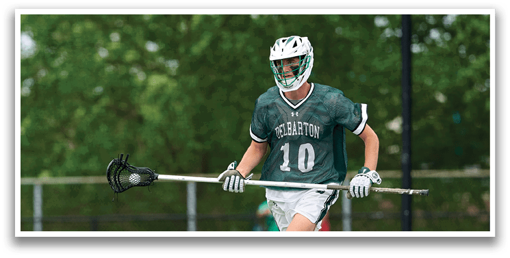 A man wearing a green and white uniform is running on a field. Description generated by AI