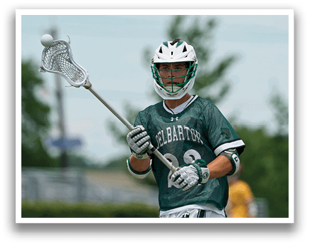 A man wearing a green and white jersey with the number 6 on it. Description generated by AI