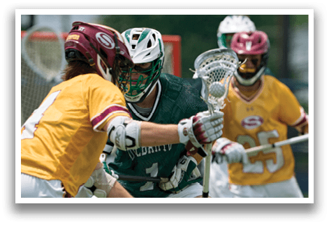 A man in a green and white uniform is holding a stick and running on a field. Description generated by AI