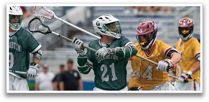A group of men playing lacrosse. Description generated by AI