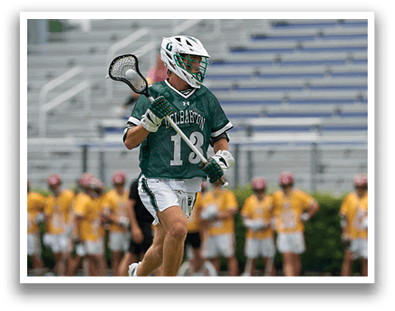 A person wearing a green and white shirt and holding a lacrosse net. Description generated by AI