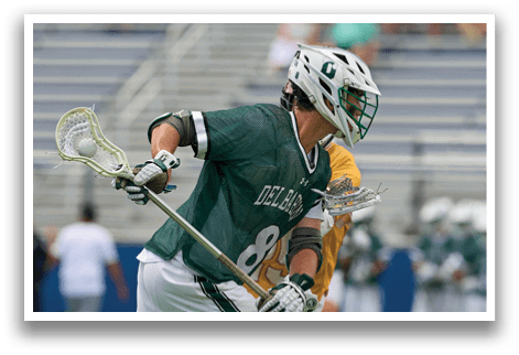 A man wearing a green and white uniform is playing baseball. Description generated by AI