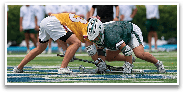A man in a green shirt is running with a lacrosse stick. Description generated by AI