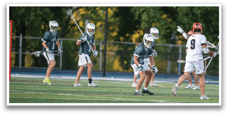 A man wearing a green and white uniform is running on a field. Description generated by AI