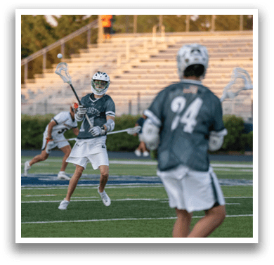 A man holding a lacrosse net. Description generated by AI