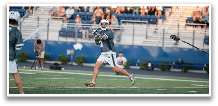 A man wearing a green and white jersey is running on a field. Description generated by AI