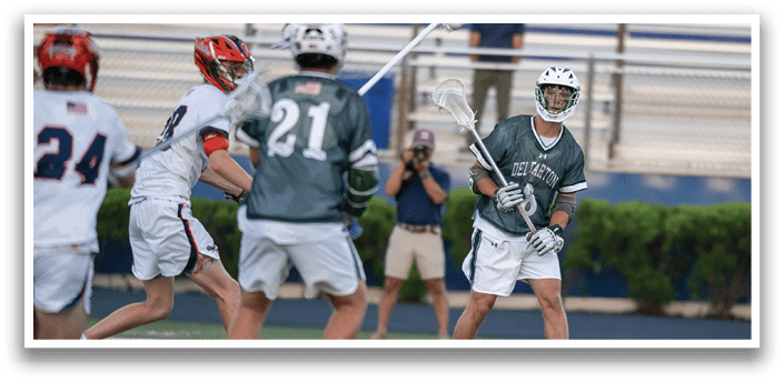 A man wearing a green and white jersey is running on a field. Description generated by AI