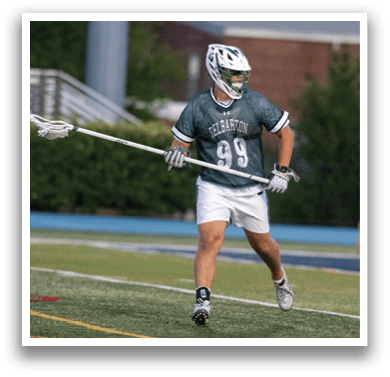 A man holding a lacrosse net. Description generated by AI