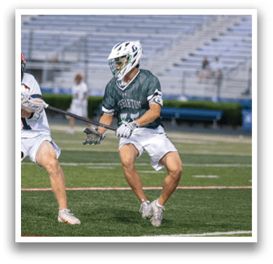 A man holding a lacrosse net. Description generated by AI