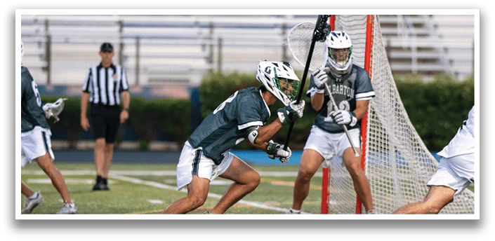 A man wearing a green and white jersey is running on a field. Description generated by AI