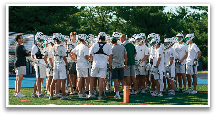 A group of young men in green and white uniforms pose for a picture. Description generated by AI