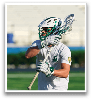 A man holding a lacrosse stick. Description generated by AI
